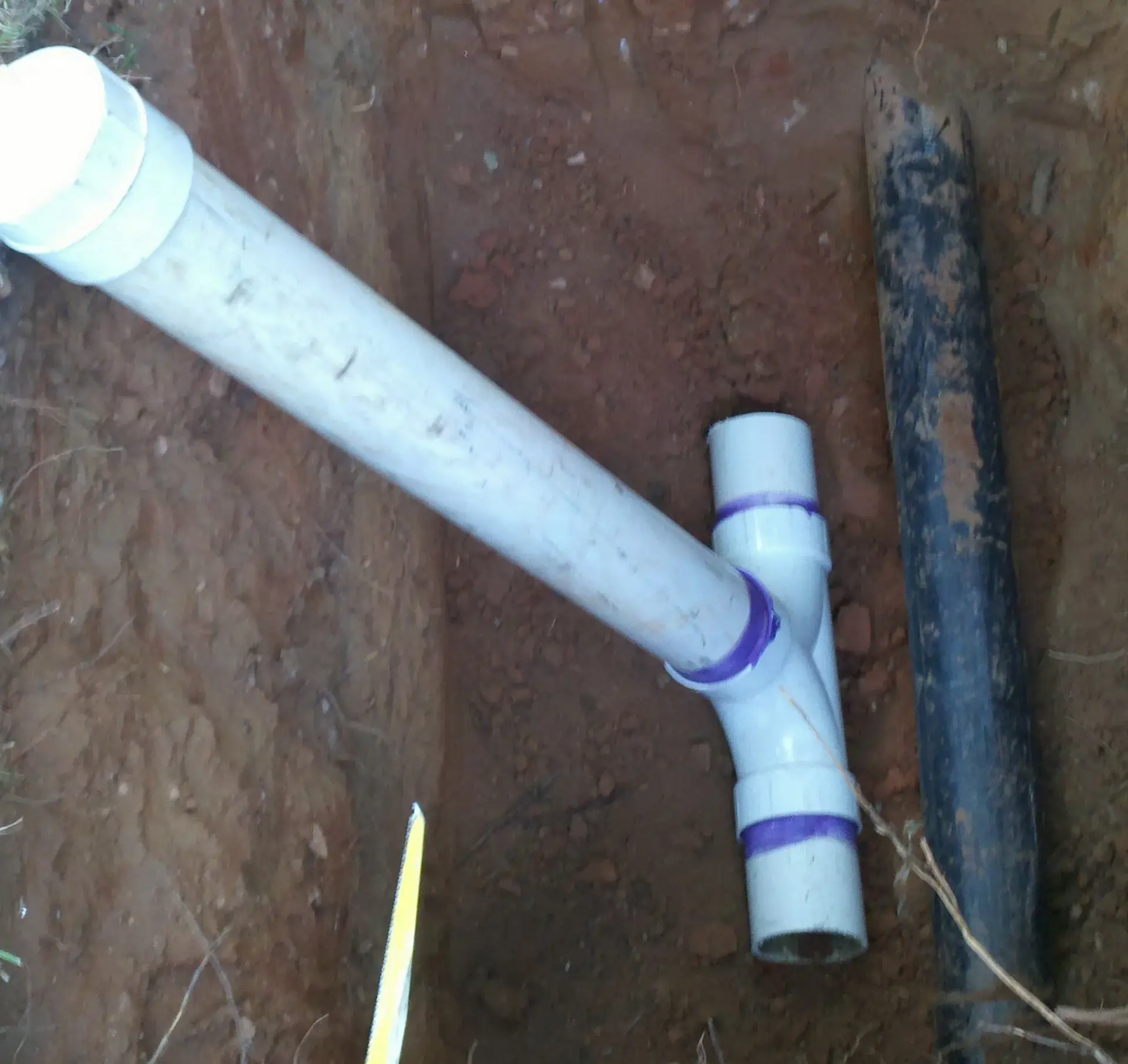 Outdoor sewer cleanout installation with PVC pipe and fittings