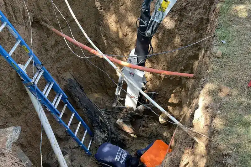 Underground plumbing in Roswell with exposed pipes in an excavated trench